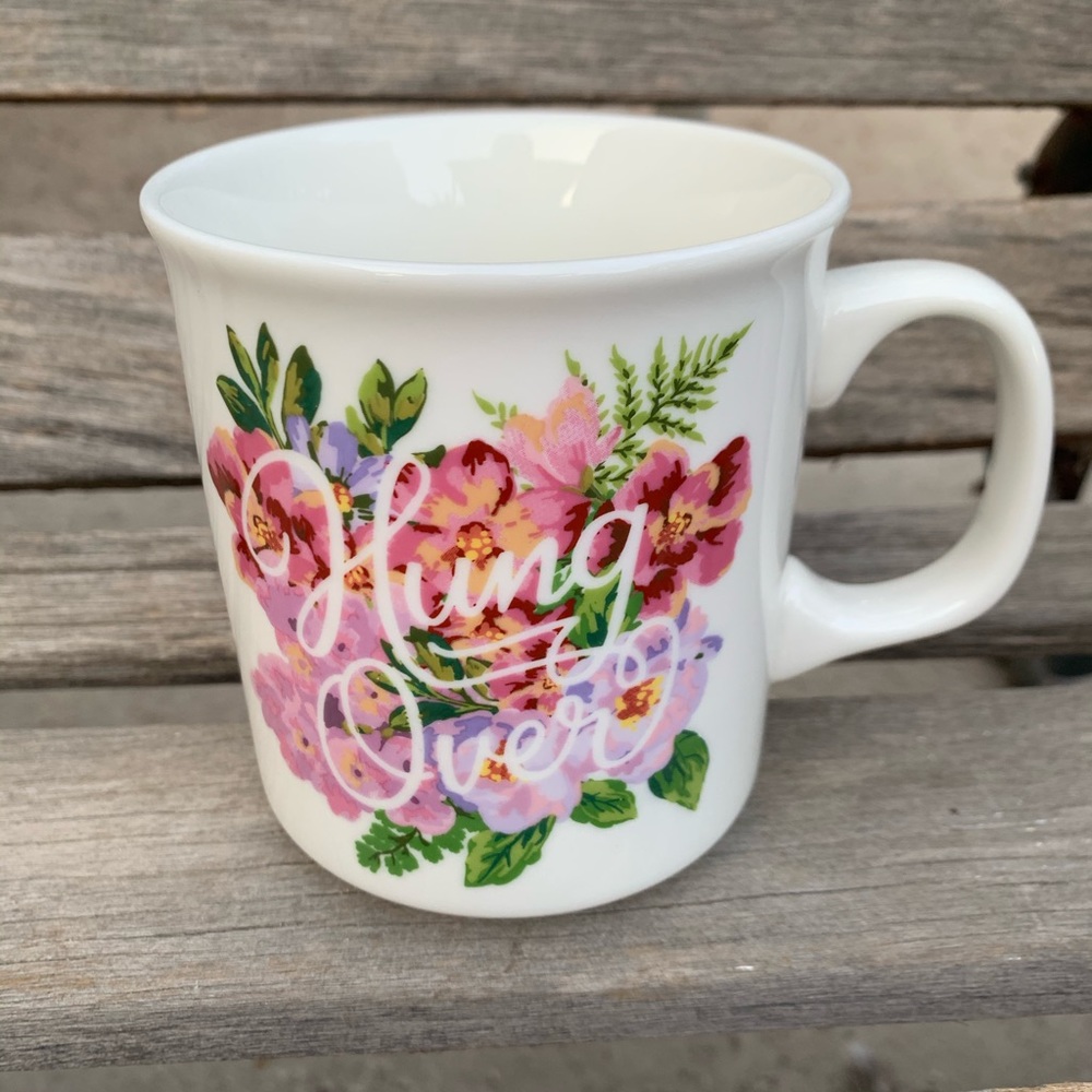 Oversized coffee mug hung over floral beverage